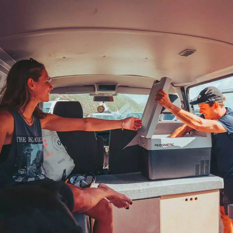 Dometic CFF35 in a old camper with a person taking something out of the coolbox and a woman helping him.