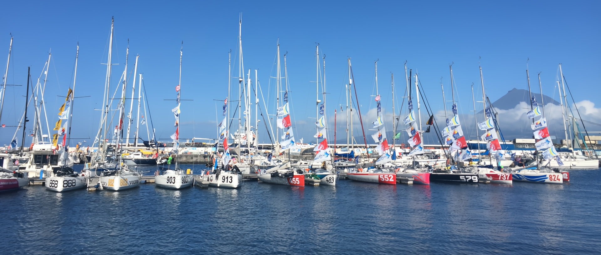 Horta Faial marina with Class Mini 6.50 on a row with a volcano on the background