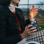 MoriMori LED lantaarn met Bluetooth speaker – oplaadbare buitenlamp in kleur Moonlight Ocean op schoot in handen van vrouw