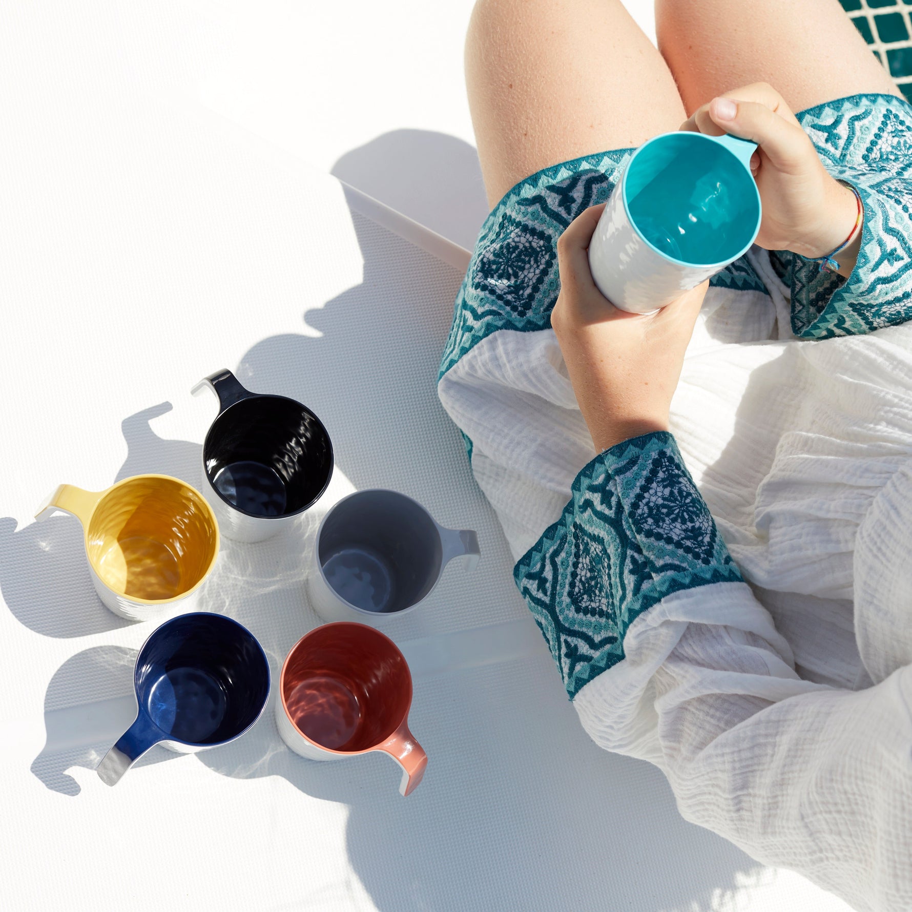 Summer serveercollectie zes kleuren op dek geplaatst naast vrouw in witte jurk